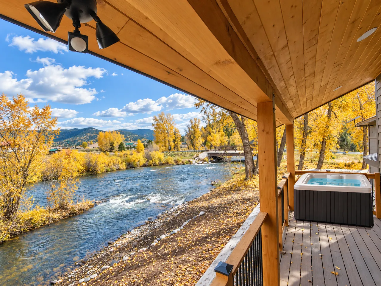 The covered porch with the river just beyond